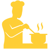 Home chef plating a dish in a Singapore communal kitchen